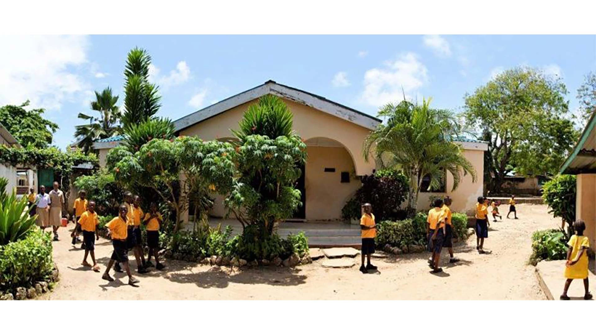 Children in uniform walking around buildings